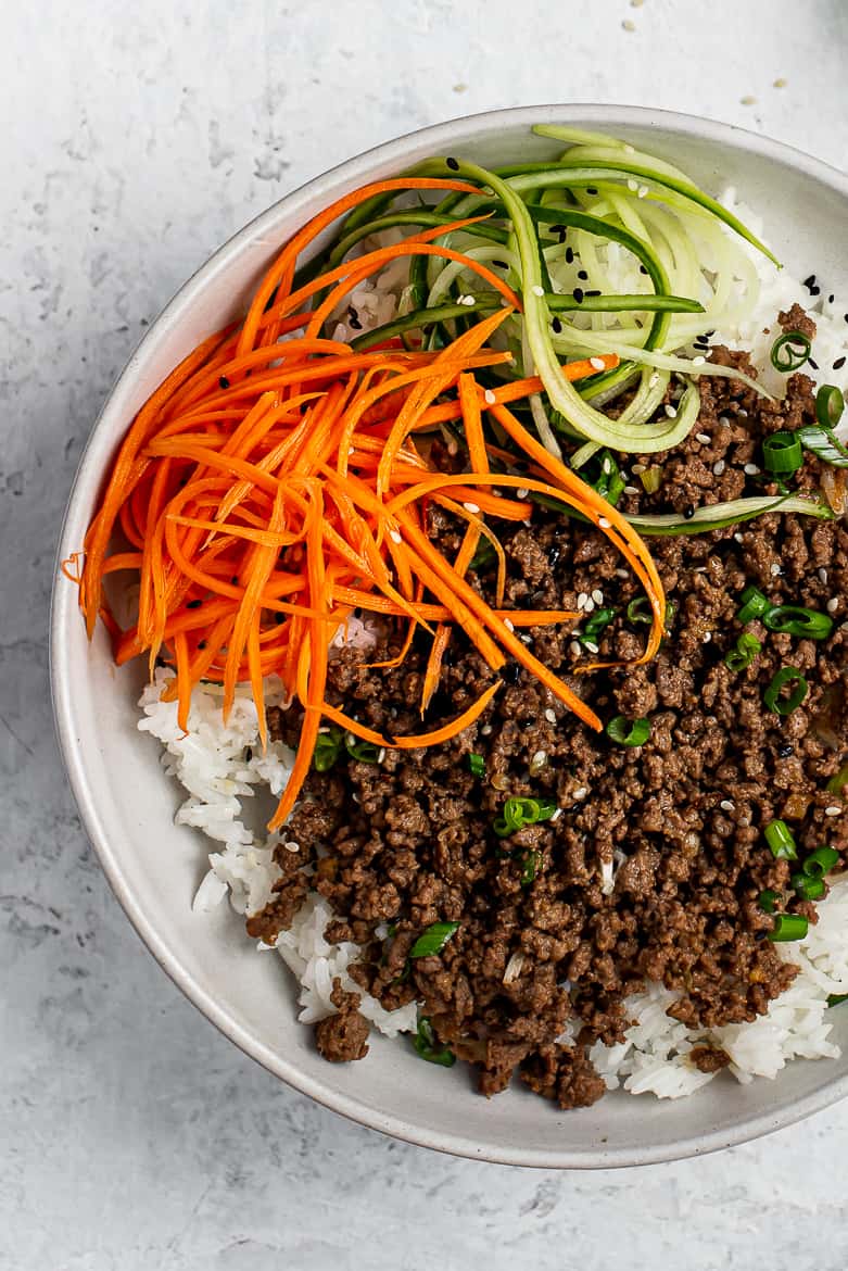 Close up of Quick Asian flavoured beef with rice with quick pickled carrots and cucumbers