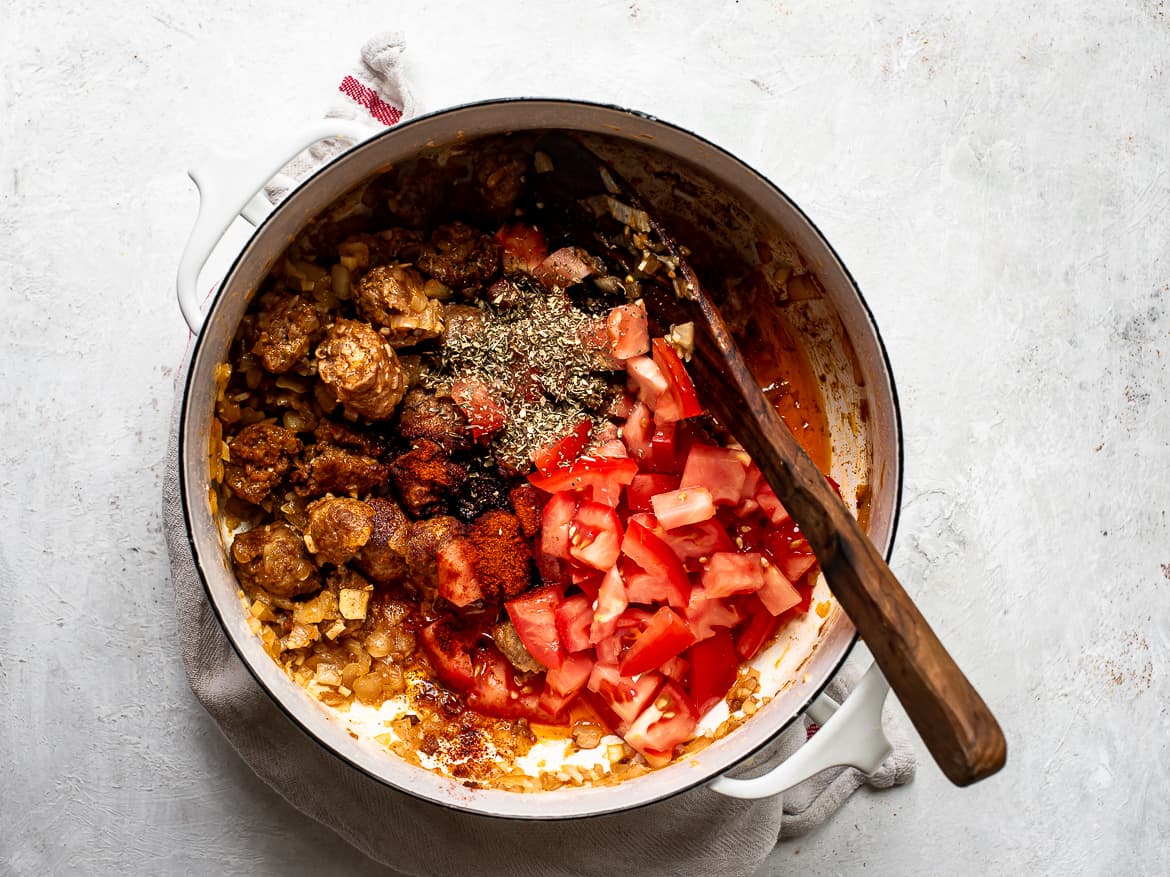 Cooking tomatoes and spices with the chorizo