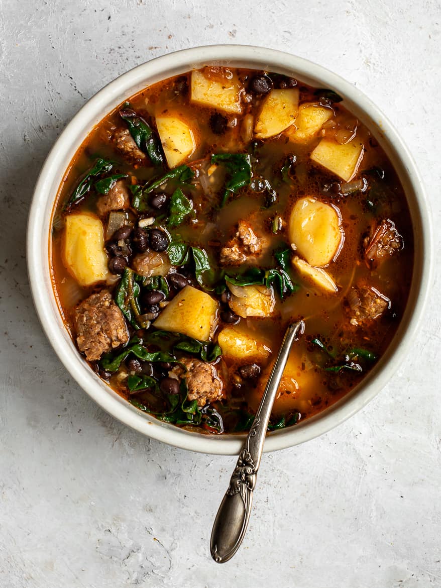 Black Bean ans sausage soup with potatoes in large serving bowl