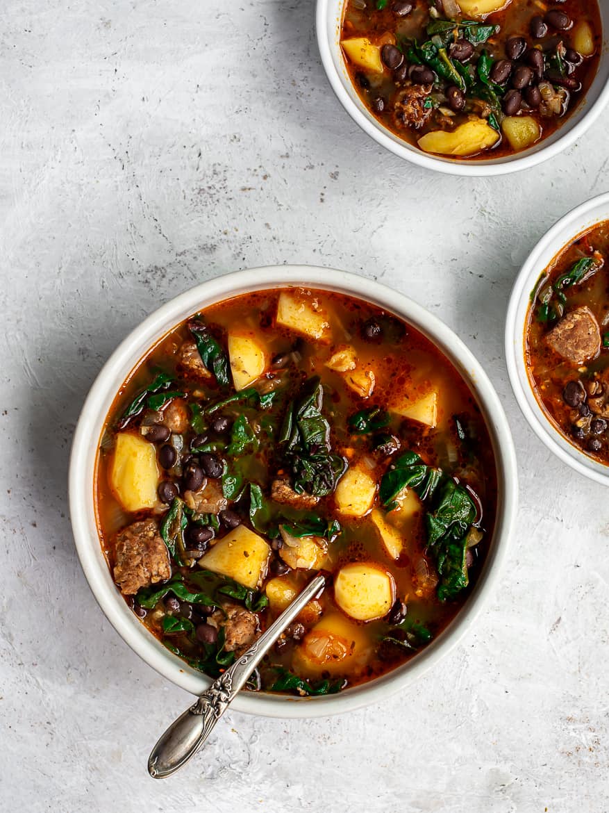 Black bean and sausage soup with potatoes in bowls