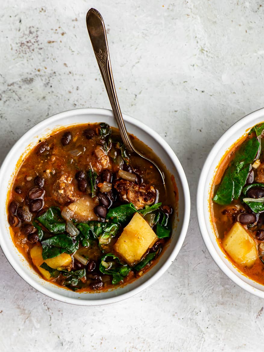 Black bean and sausage soup with potatoes in two bowls