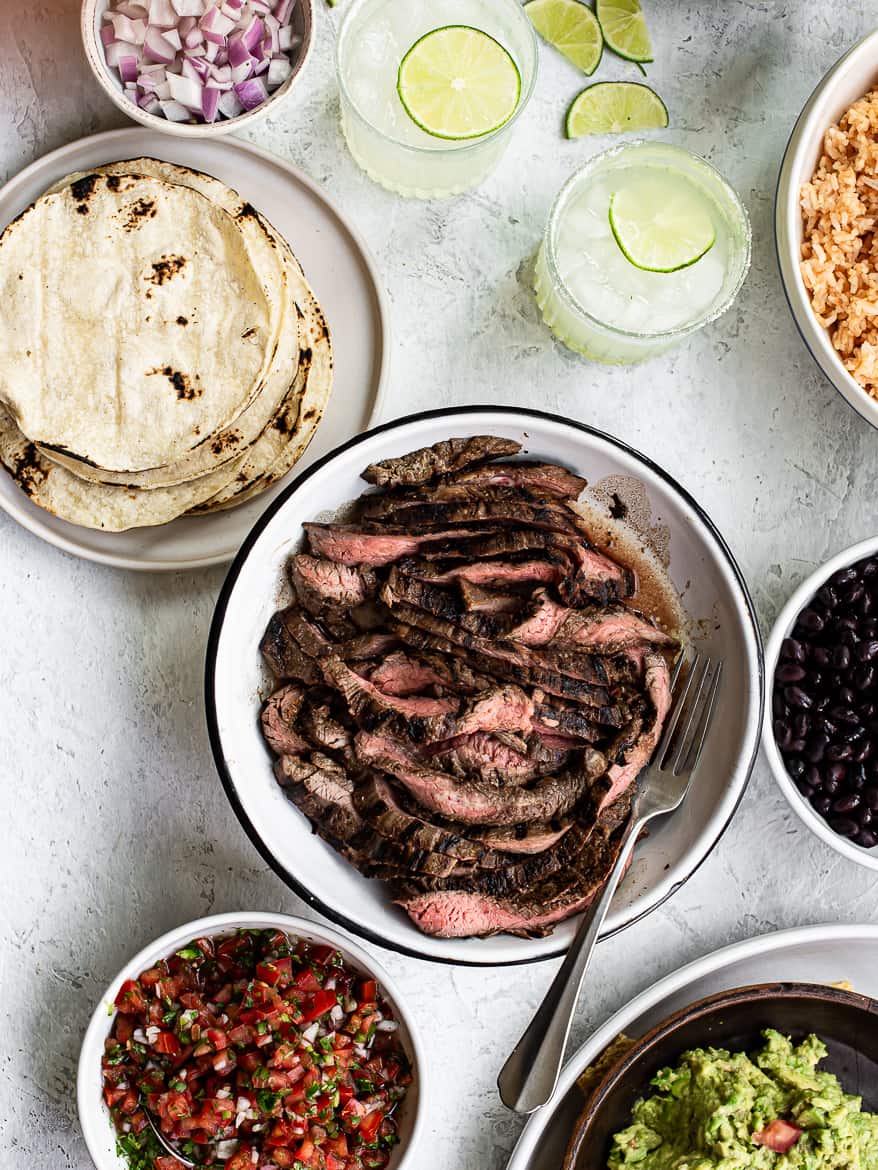 Steak, mexican rice, pico de gallo, black beans, corn tortillas for cinco de mayo feast