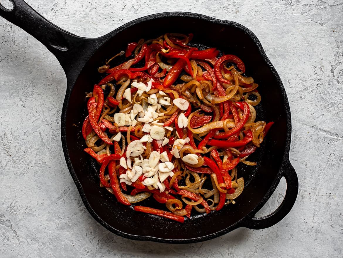 Sautéing onions and red peppers with garlic