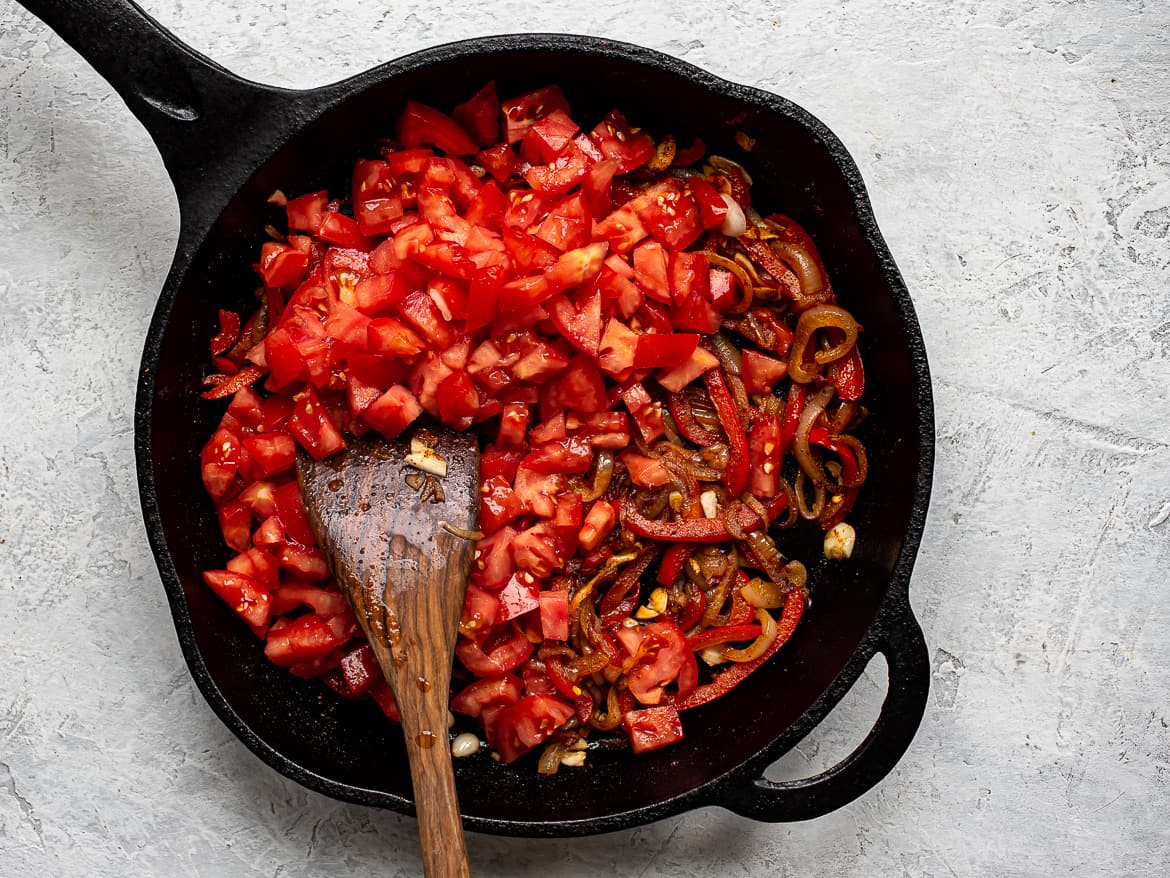 Adding tomatoes to the onion mixture