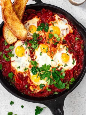 Shakshuka in skillet with challah