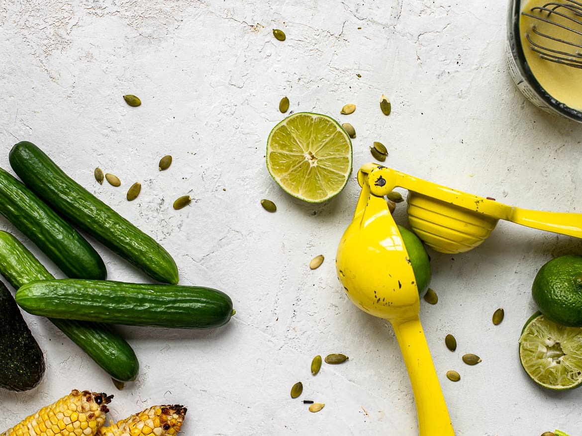 A few salad ingredients; limes, avocados, cucumbers, lime squeezer