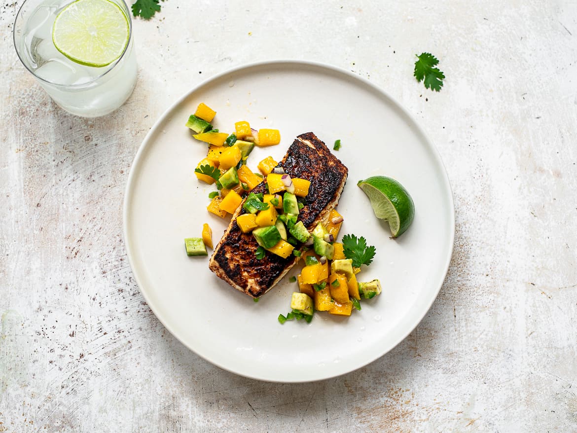 cooked fish with mango salsa on plate