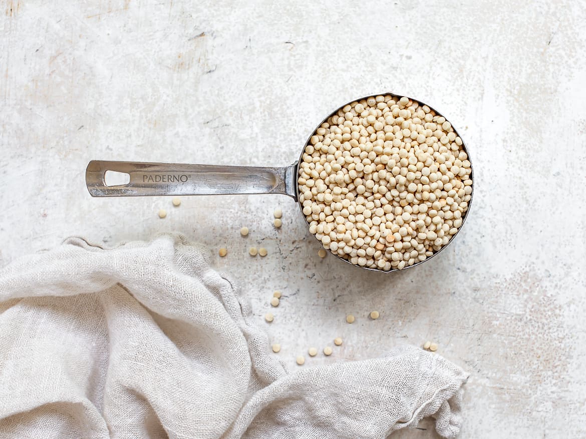 Dried pearl couscous in measuring cup