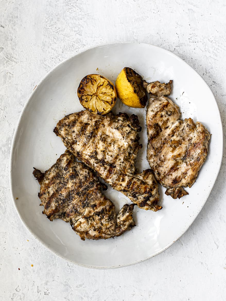 Grilled chicken resting on platter 