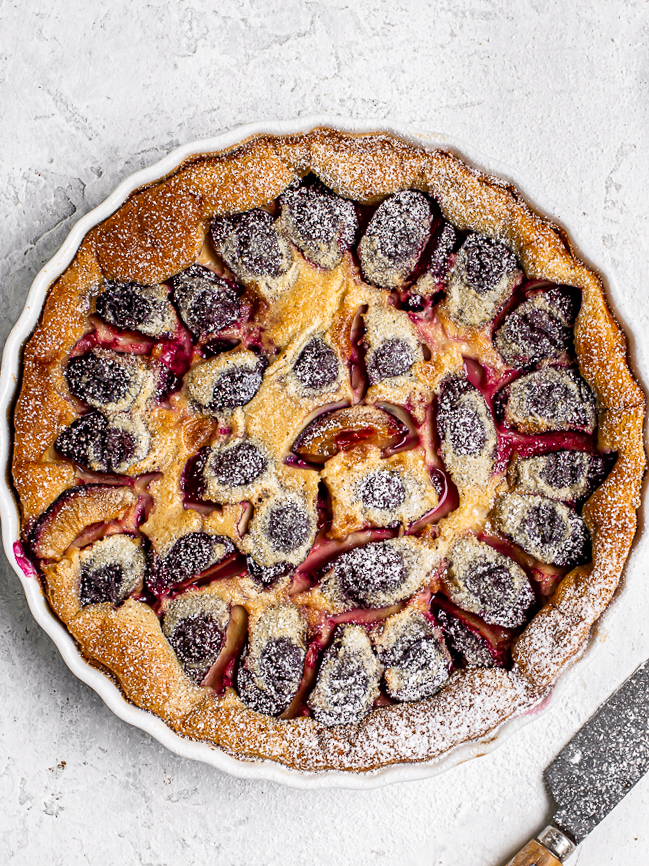 Plum clafoutis dusted with powdered sugar