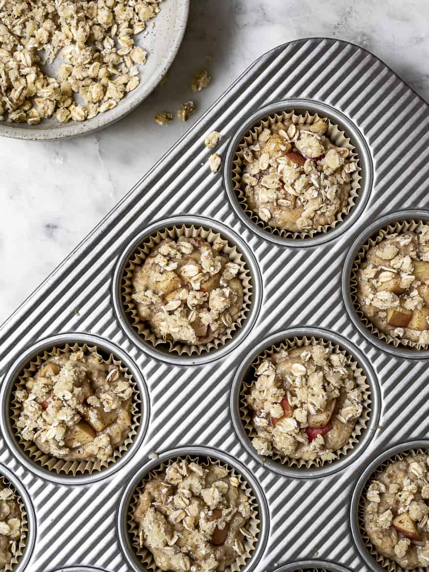 Apple muffins in muffin tin topped with crumble