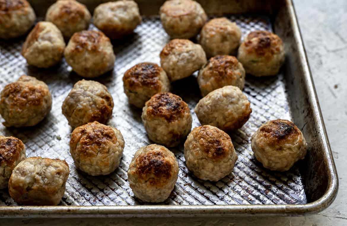 Baked chicken meatballs on baking sheet