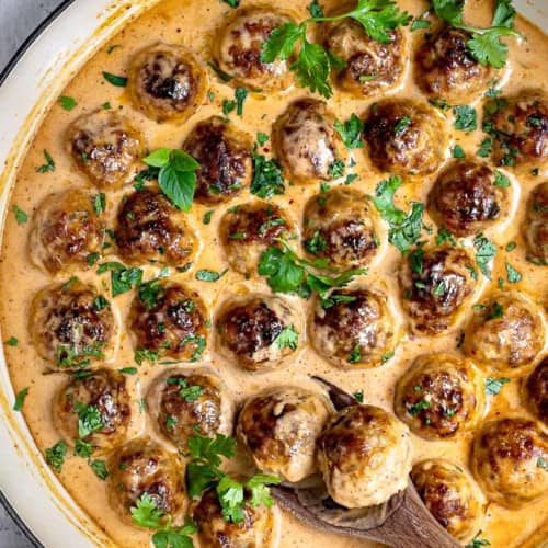Scooping out Chicken Meatballs with Thai curry Sauce in pan