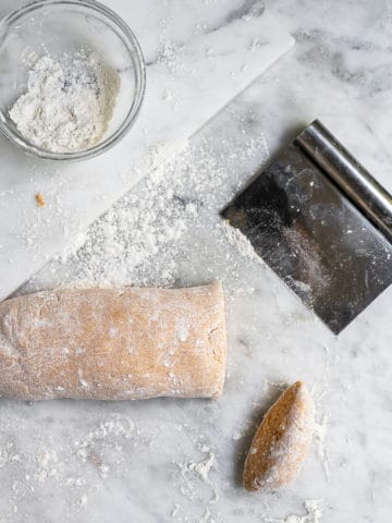 Cutting piece of dough to make sweet potato gnocchi