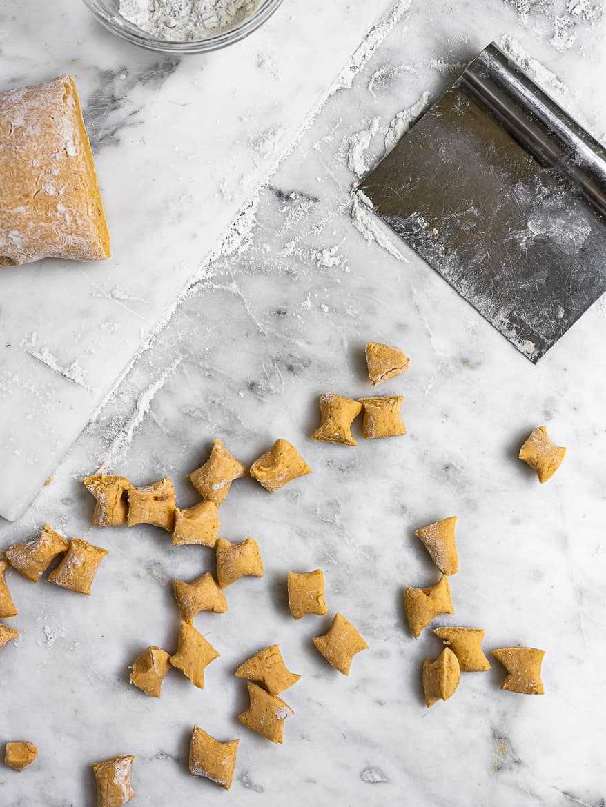 Cut pieces of gnocchi on counter