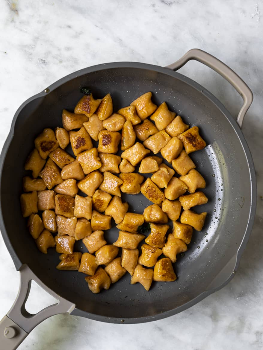 Sweet potato gnocchi getting crispy in pan