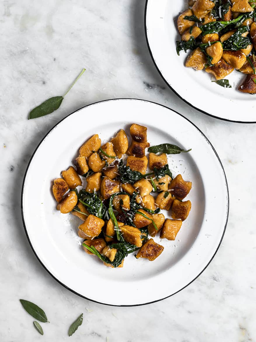 Sweet Potato Gnocchi in skillet with browned butter and sage in bowls