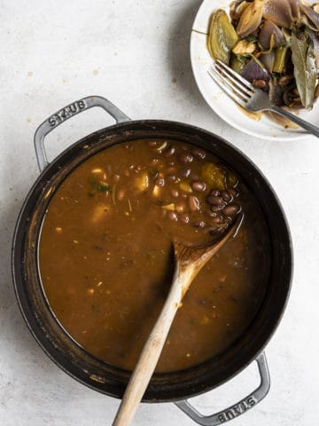 Removing vegetables fromCooked Habichuelas guisadas in pot