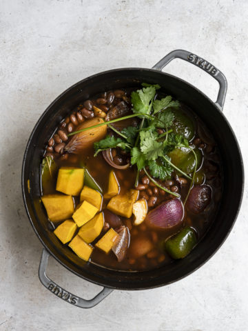 Cooking beans with squash and vegetables in pot