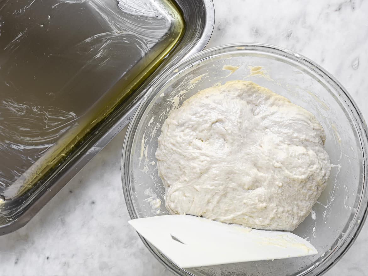 deflated dough about to go into buttered pan