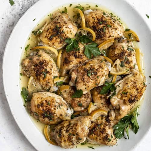 baked lemon chicken thighs on platter