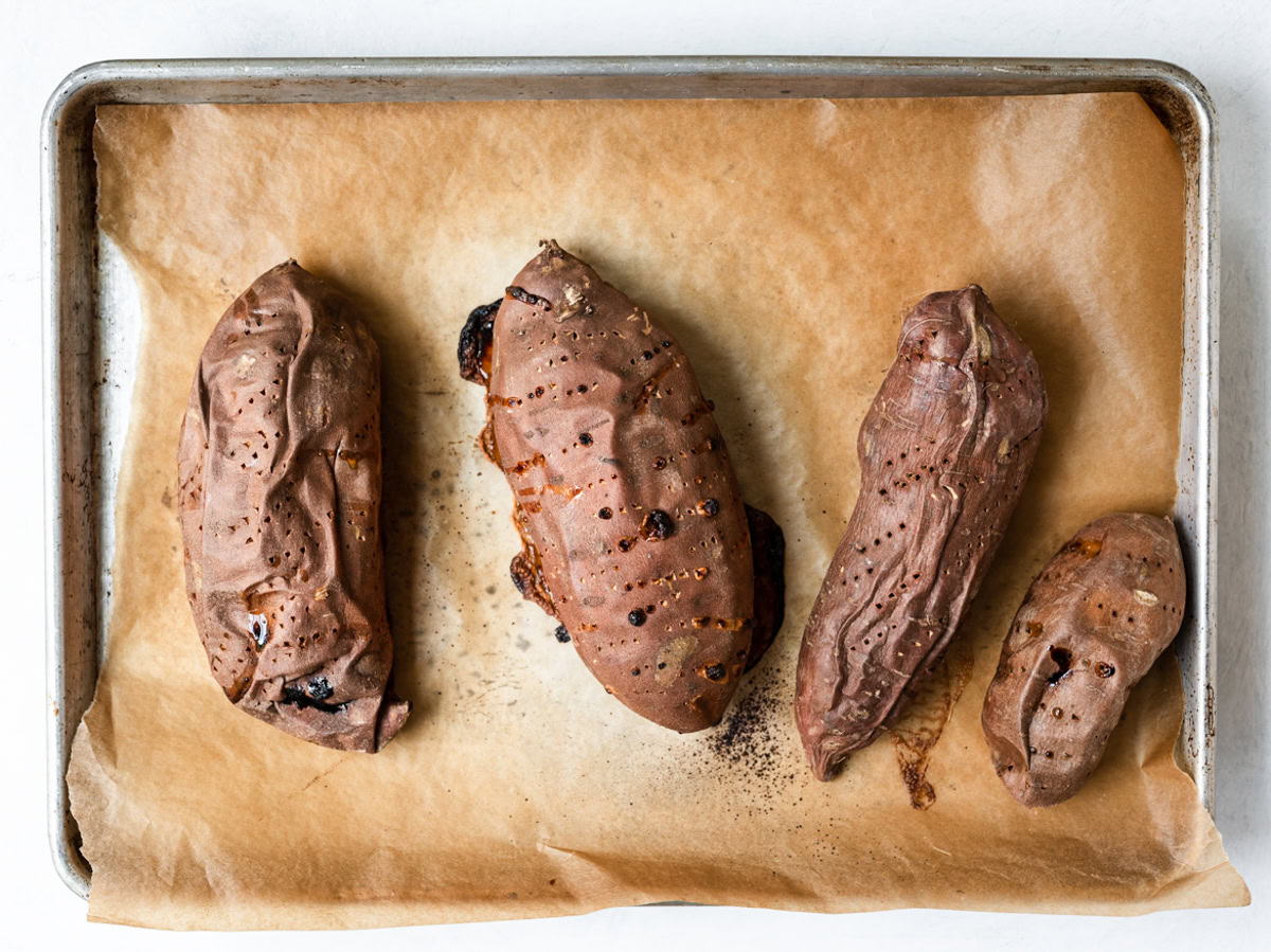 baked sweet potatoes on baking sheet