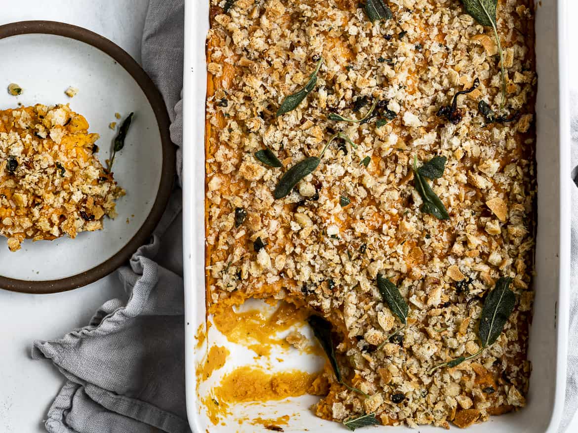 Serving a piece of Sweet Potato Casserole on a plate