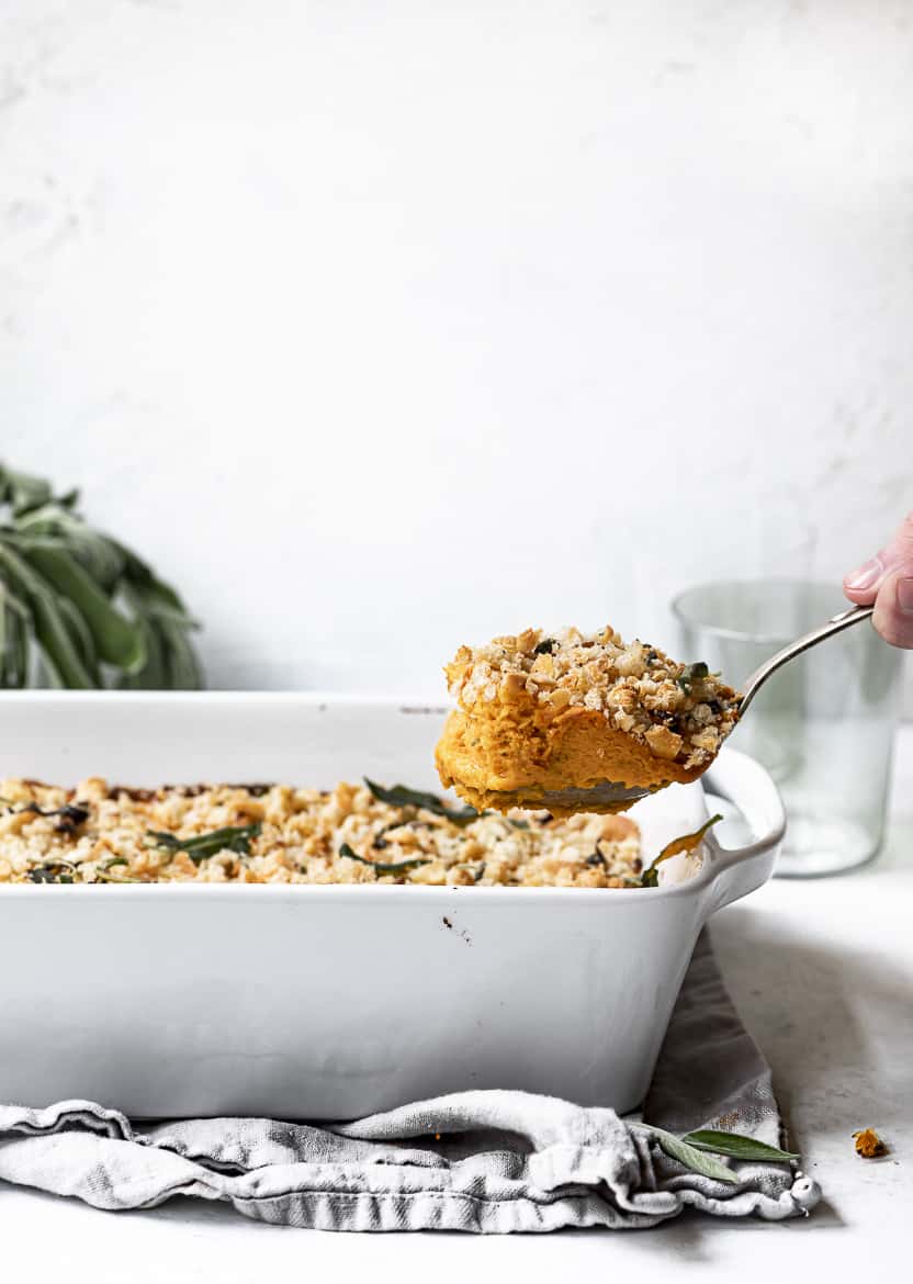 Scooping out a pice of Savoury Sweet Potato Casserole