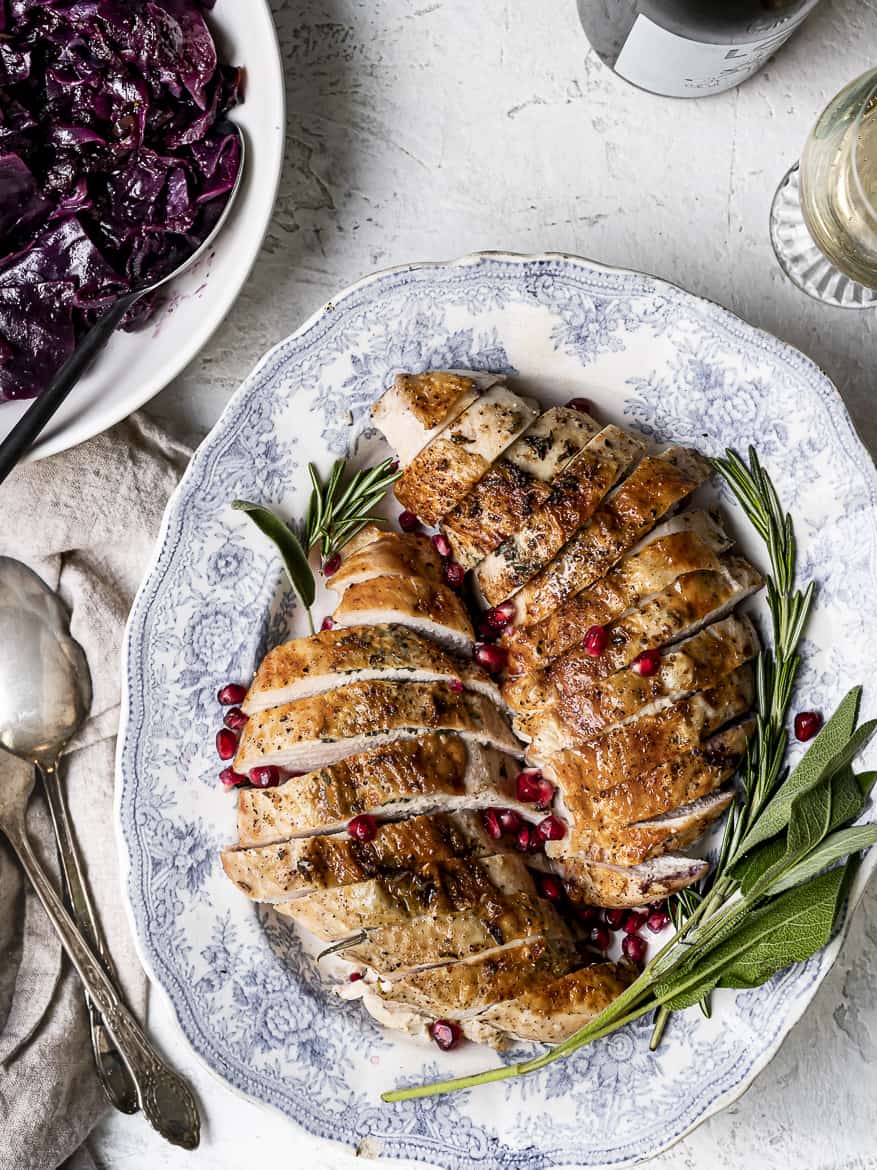 Turkey breast sliced on platter with red braised cabbage on the side