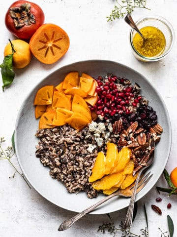 Mixing wild rice salad ingredients in bowl