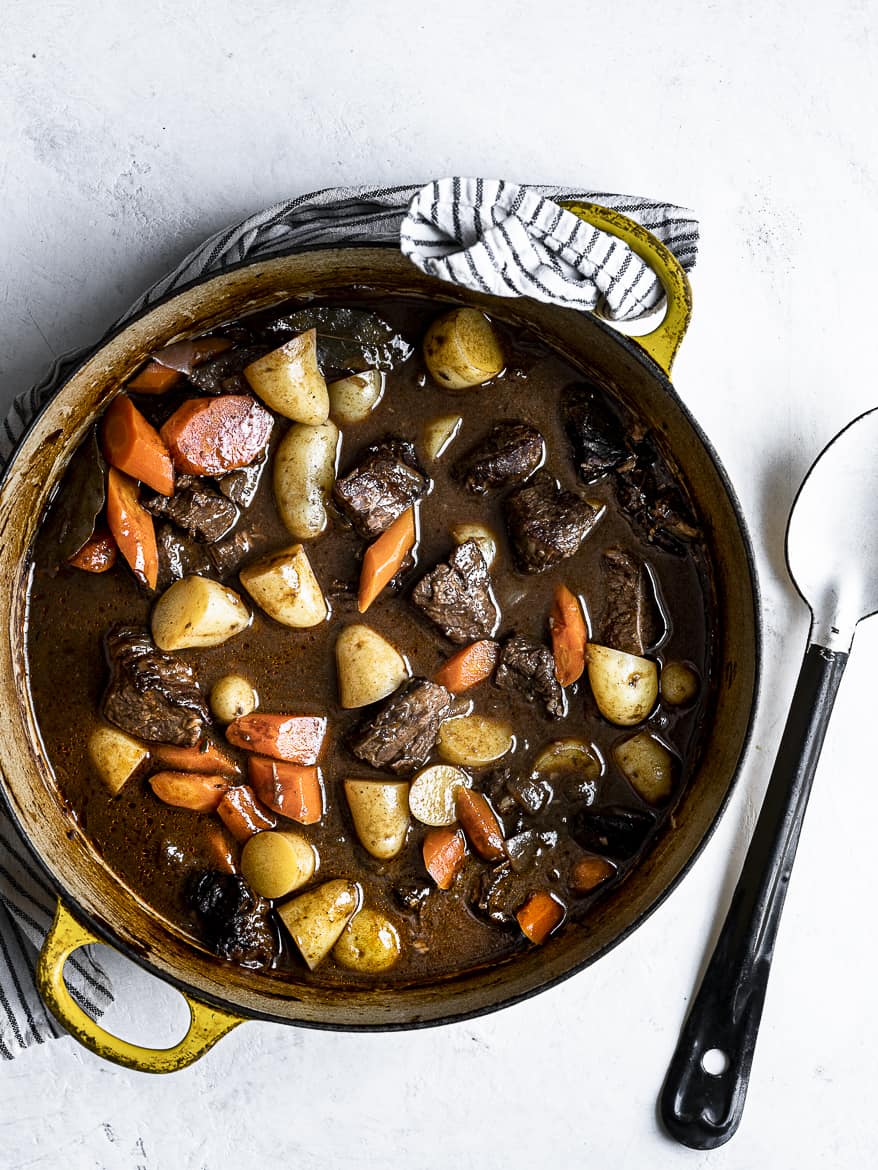 Beef stew in pot with serving spoon