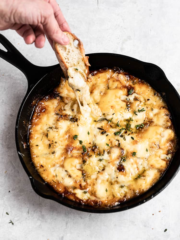 Dipping with crostini into the baked cheese