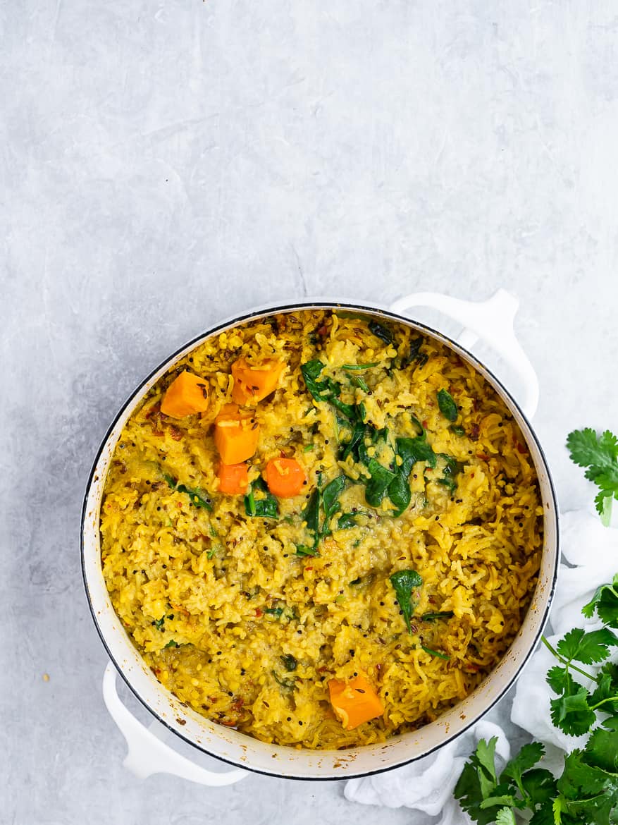 Khichdi with vegetables in pot with cilantro leaves