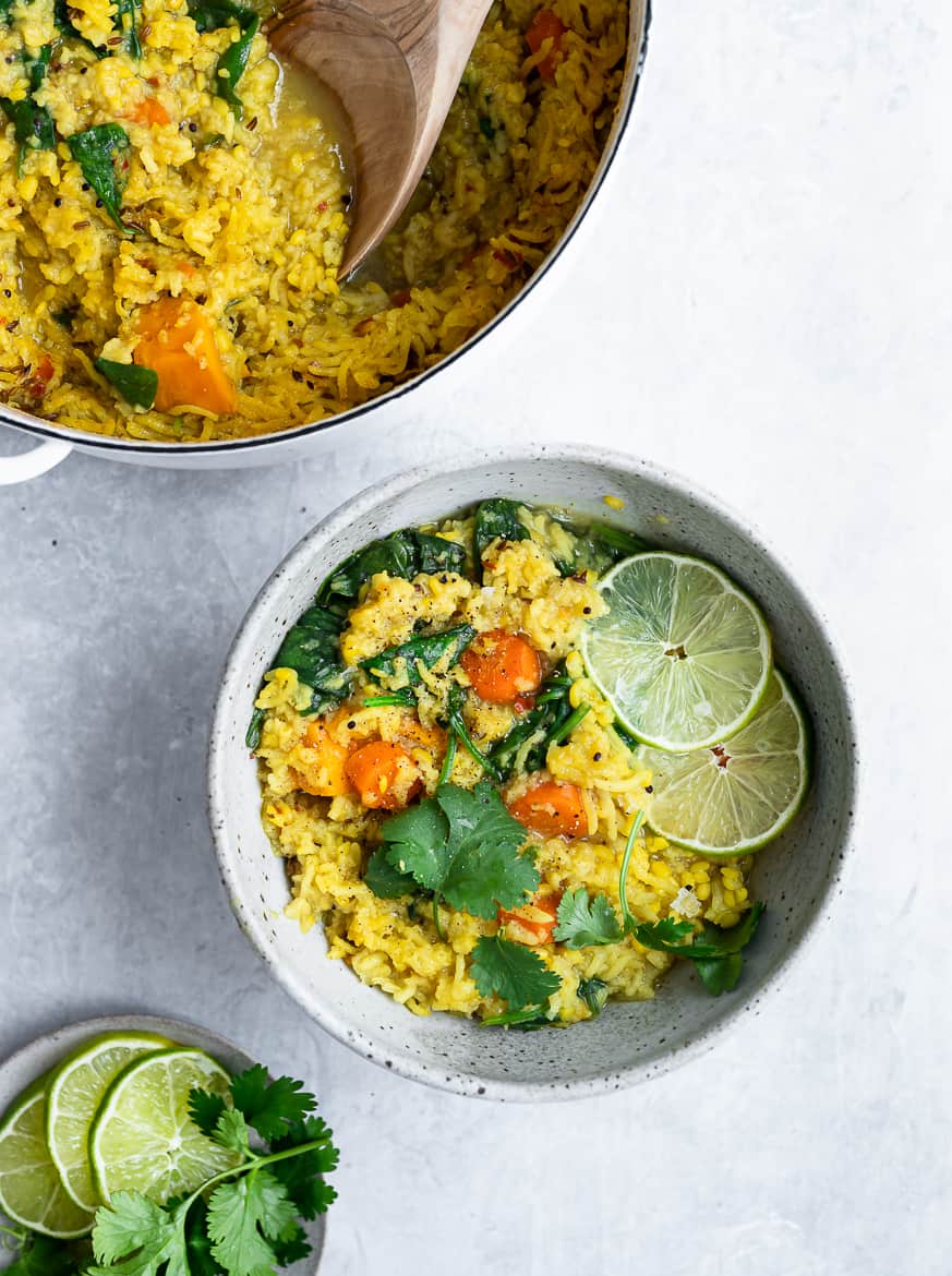 Serving khichdi in bowls with lime wedges