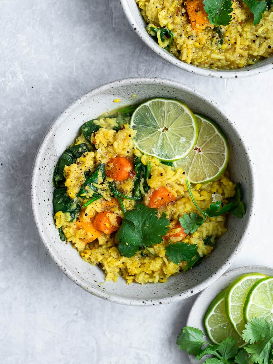 Khichdi in bowls with lime wedges