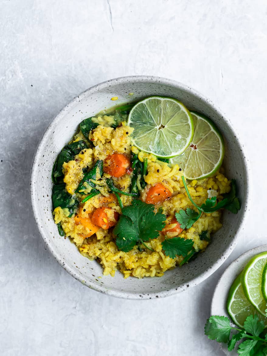 Khichdi in bowl with lime wedges