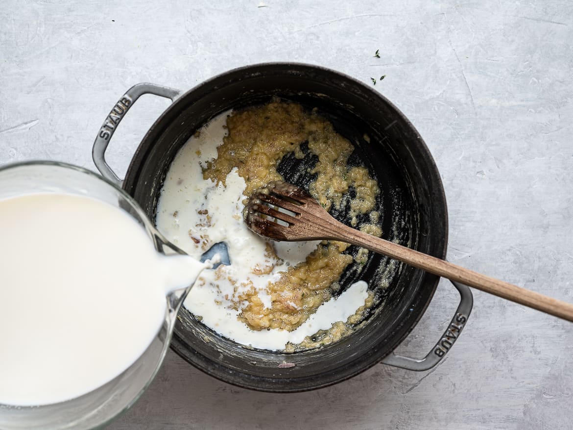 Pouring milk to make roux