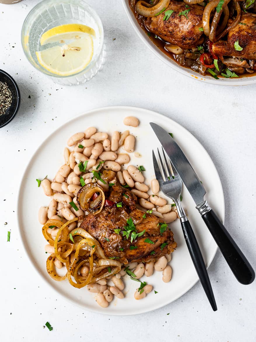 Instant Pot Chicken thighs on plate with marinated beans