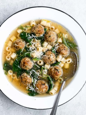 Italian Wedding soup served in bowl with spoon