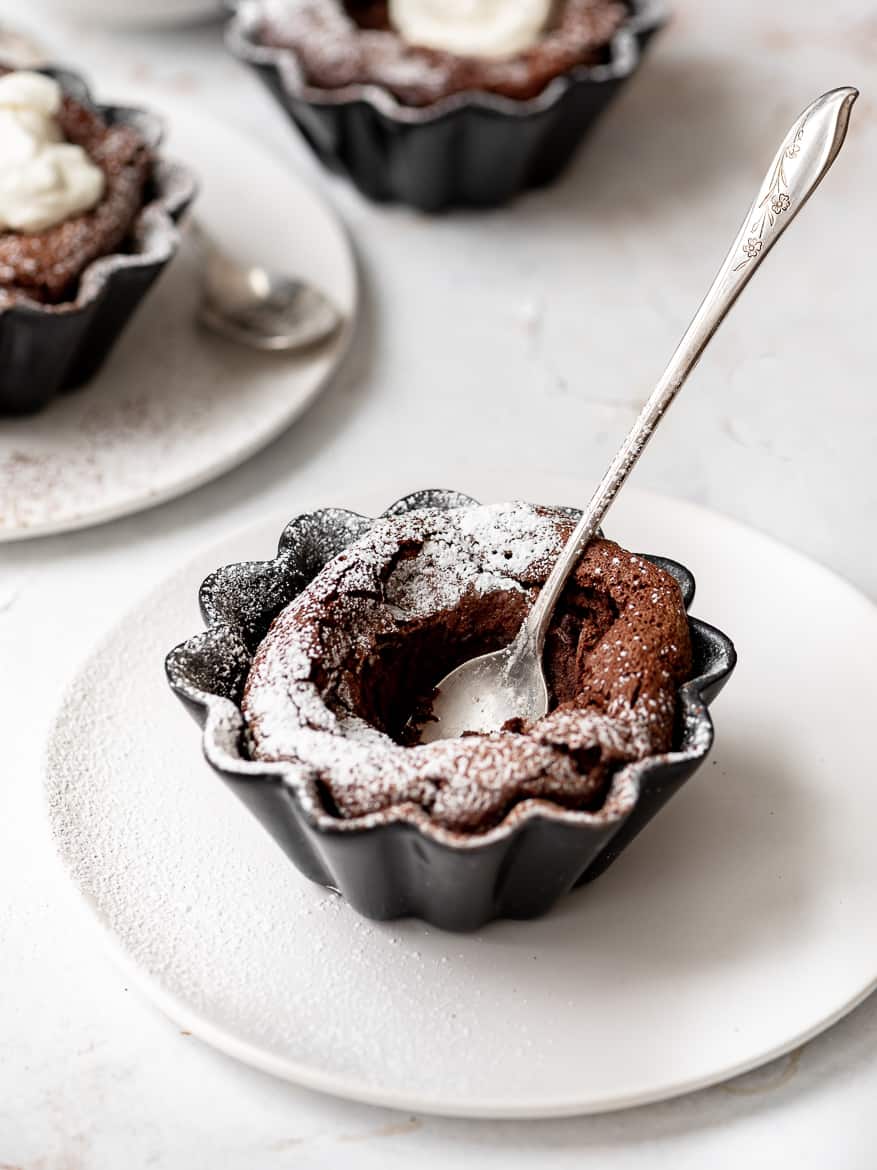 Fallen Chocolate Soufflé Cake with whipped and dusting of powdered sugar