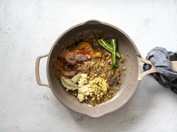 Adding spices to the onion in skillet