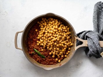 adding chickpeas to skillet