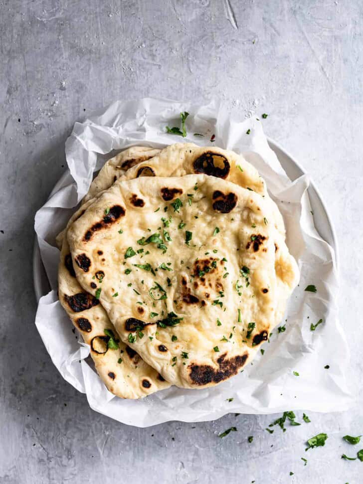 Stack of Homemade Naan with butter and flaky salt