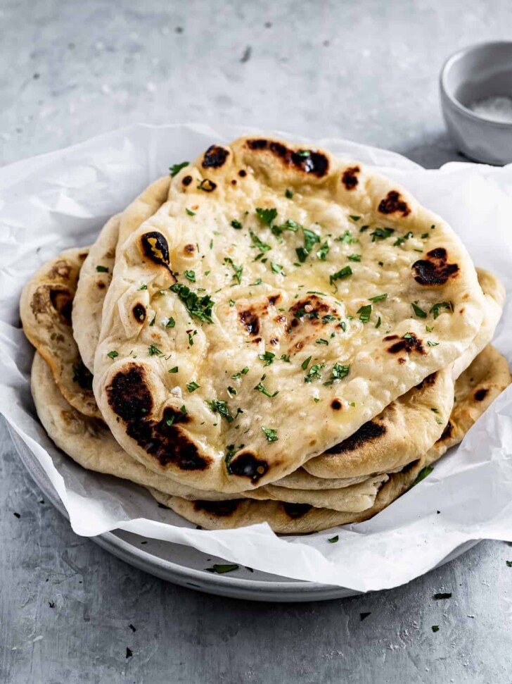 close up of Homemade Naan with butter and flaky salt