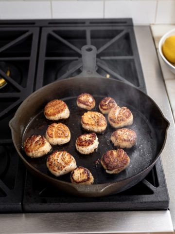Scallops searing in skillet