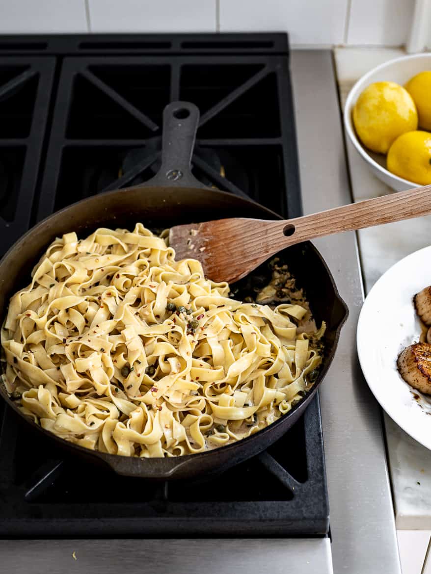 tossing pasta with skillet sauce