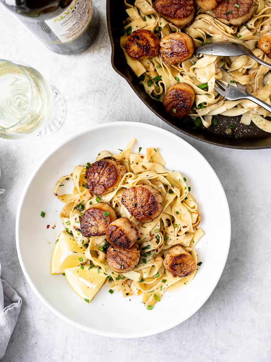 serving Pan Seared Scallops with Lemon pasta in bowls