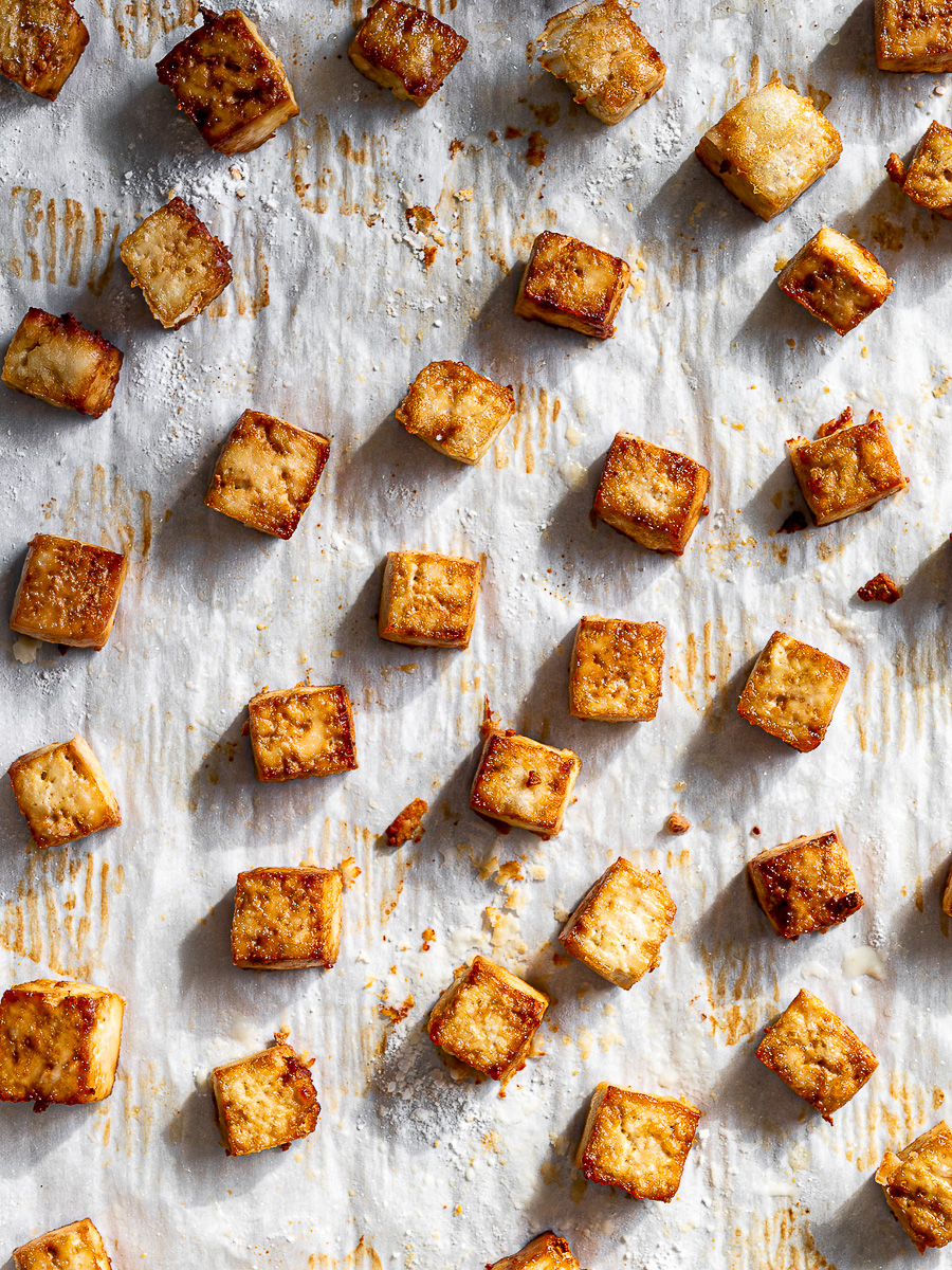 Crispy roasted tofu cubes on sheet pan. 