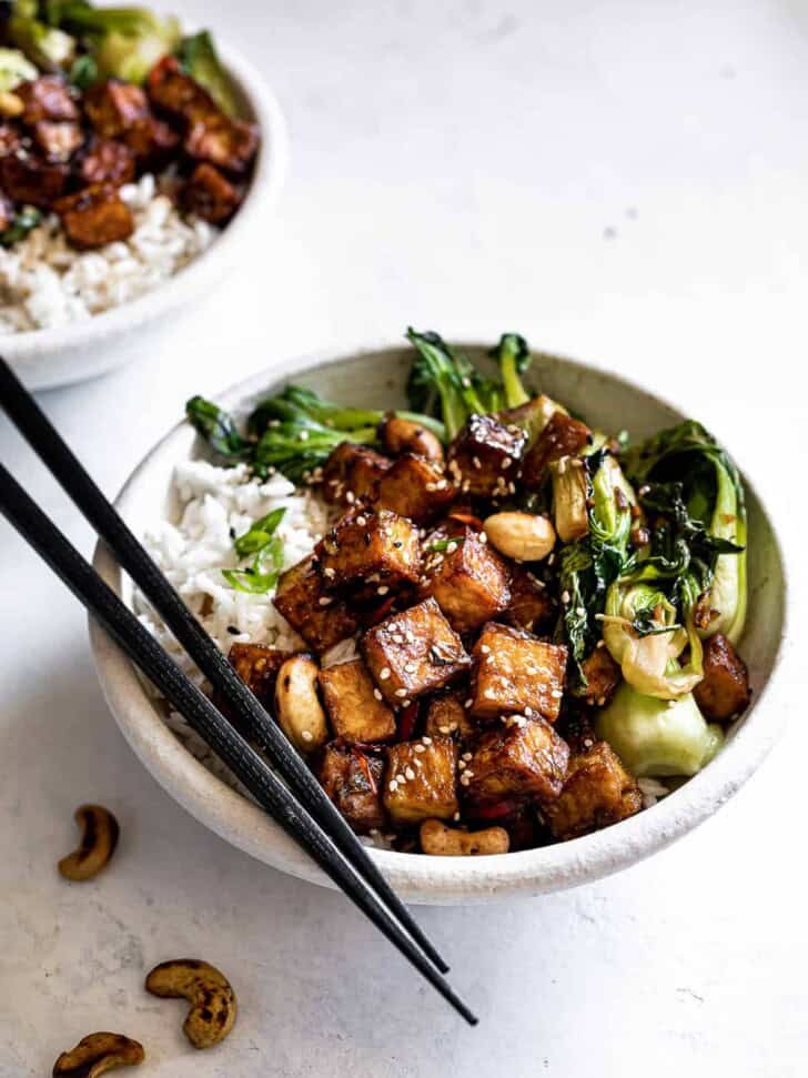 Tofu and Bok Choy stir fry in bowls with chop sticks 