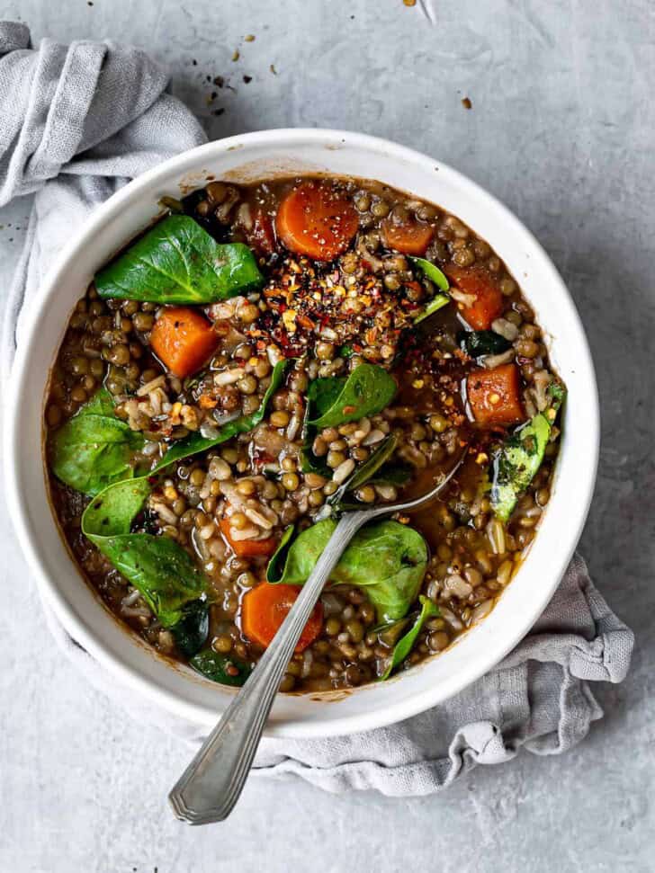 Close up of Lentil and brown rice soup in bowl with spoon